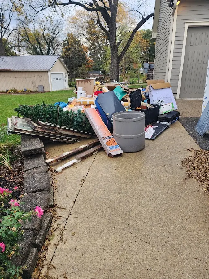Dumpster being loaded with debris for Estate Cleanout Dumpster Rental in Wonder Lake